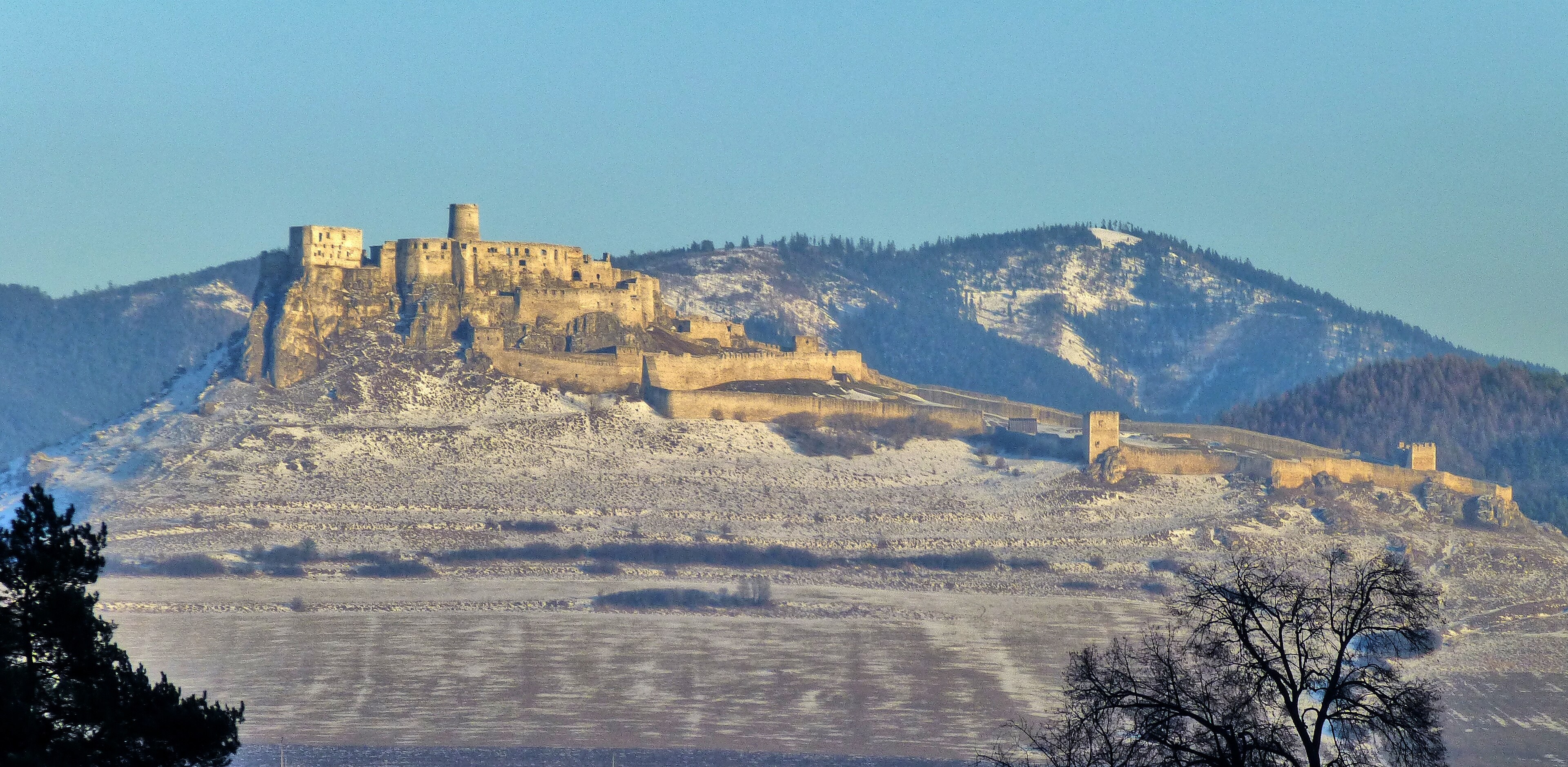 Spiš Castle on its travertine hill, a long ruin above the valley